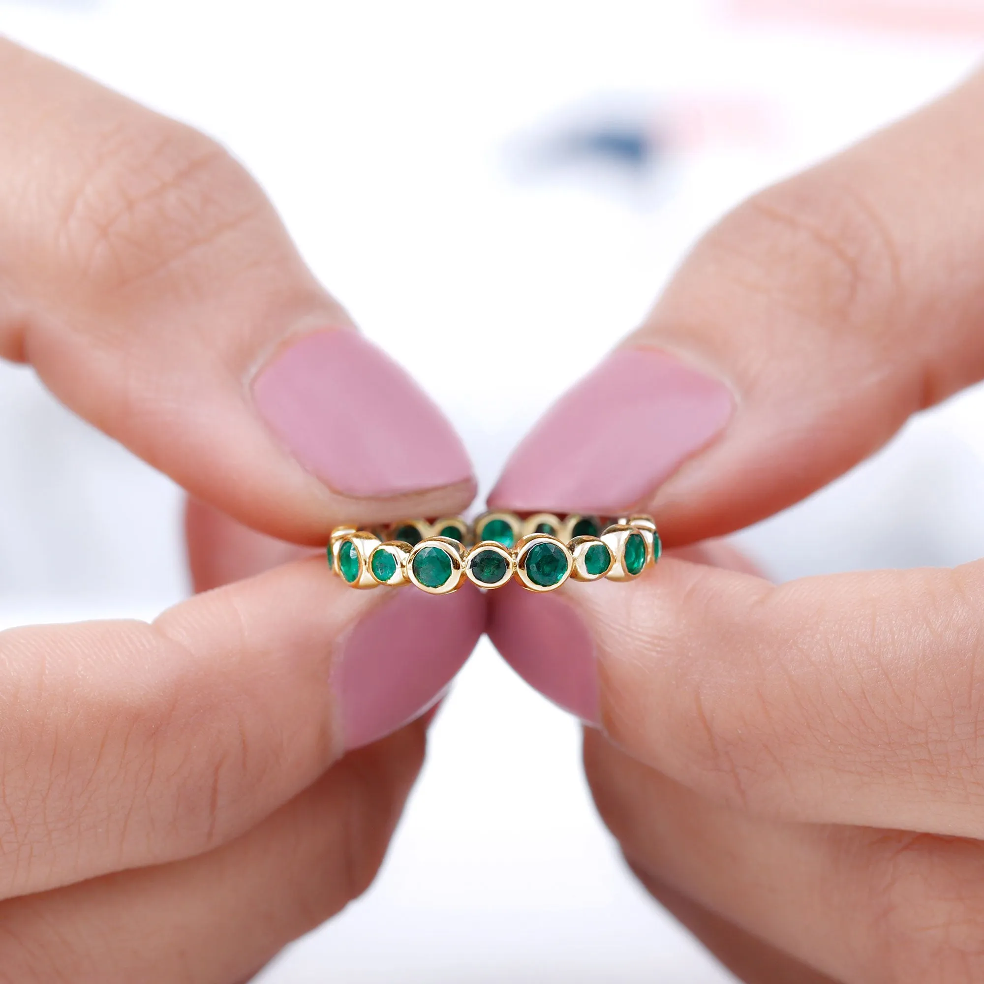 1 CT Emerald Uneven Eternity Ring in Bezel Setting