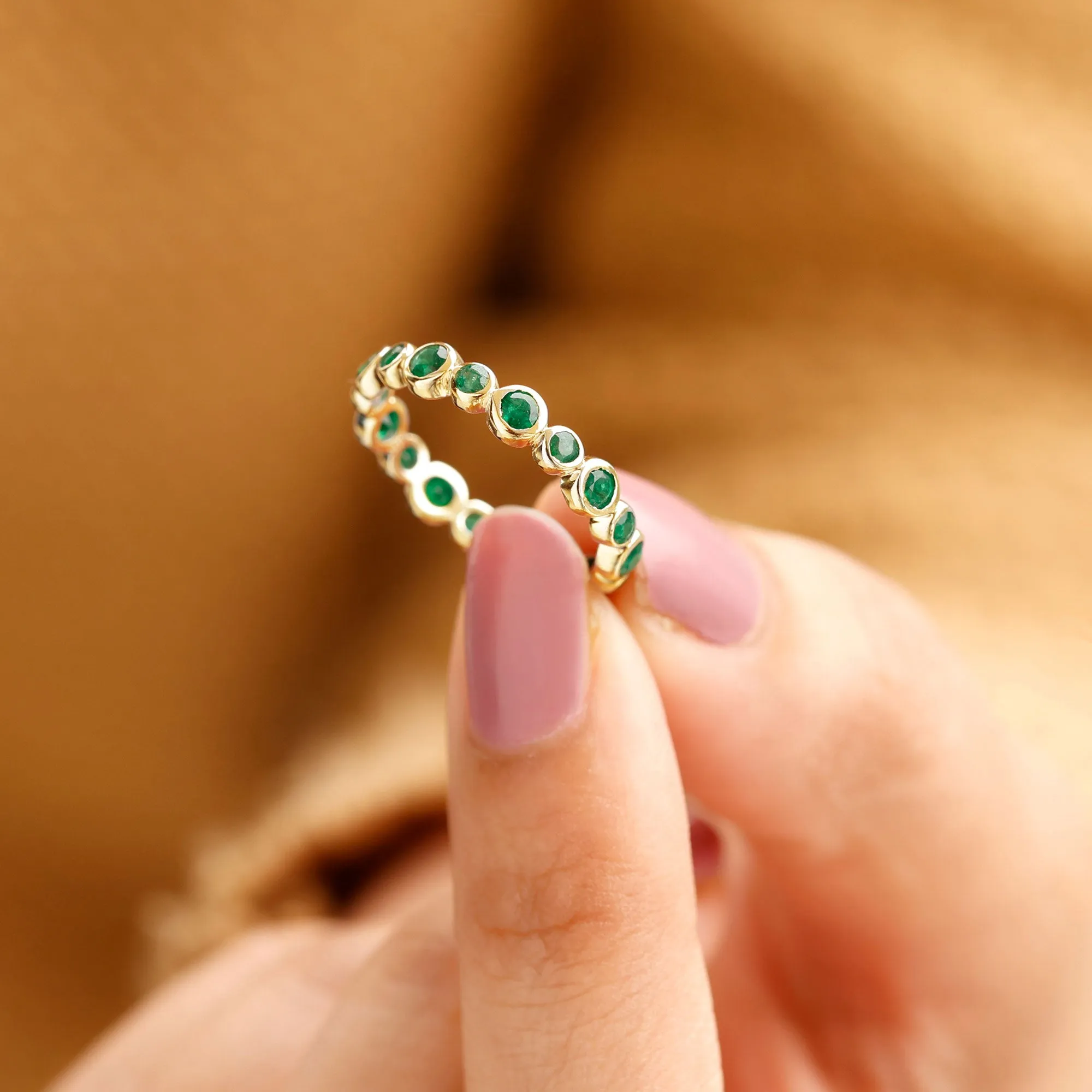 1 CT Emerald Uneven Eternity Ring in Bezel Setting